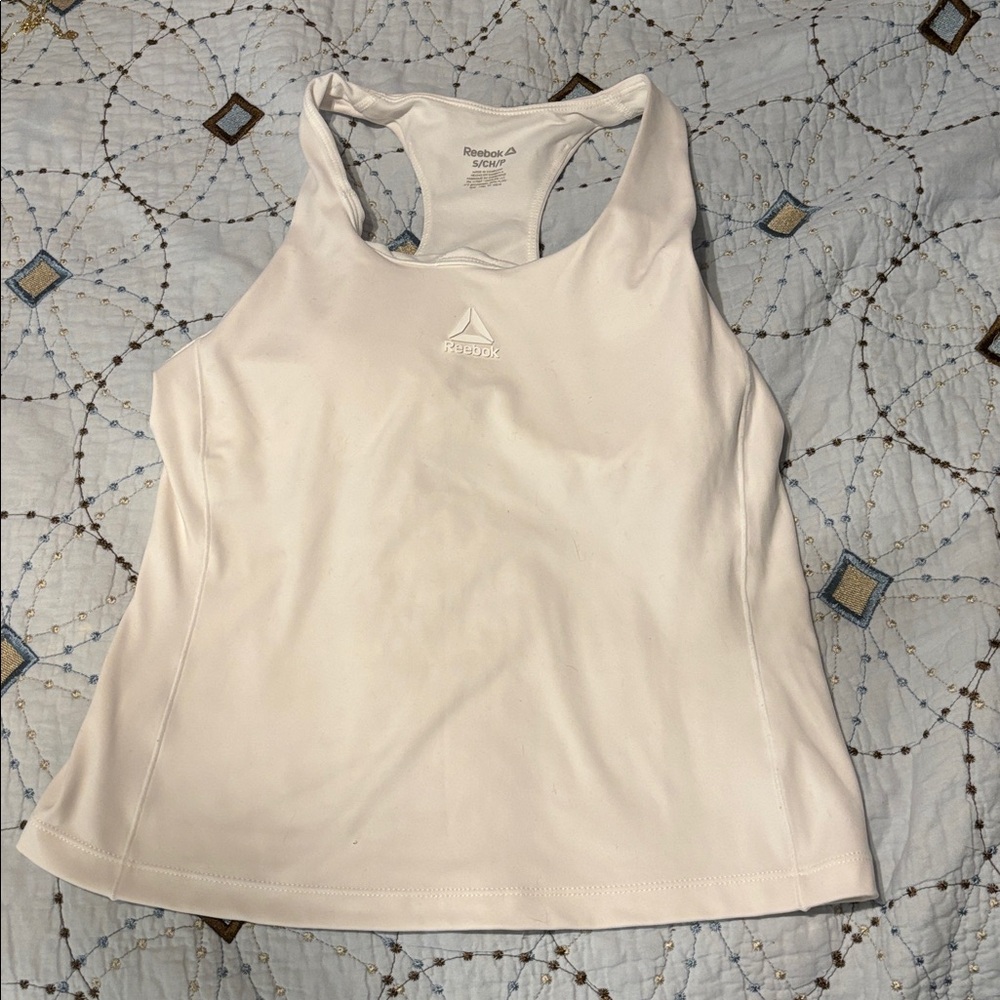Brand is Reebok the size is small and the color is white. Also has built in bra.